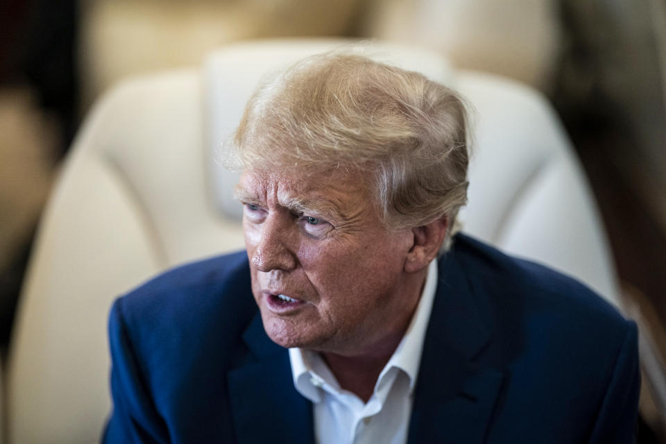 Former President Donald Trump onboard his airplane as he is flown to Iowa on March 13, 2023. (Jabin Botsford / The Washington Post via Getty Images file)