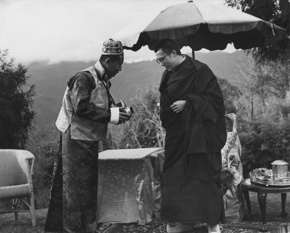 The Dalai Lama takes a look at a camera held by <a href="http://www.nytimes.com/1982/01/30/obituaries/palden-thondup-namgyal-deposed-sikkim-king-dies.html?pagewanted=all" target="_blank">Palden Thondup Namgyal</a>, the deposed King of Sikkim, which was once a protectorate of India.&nbsp;