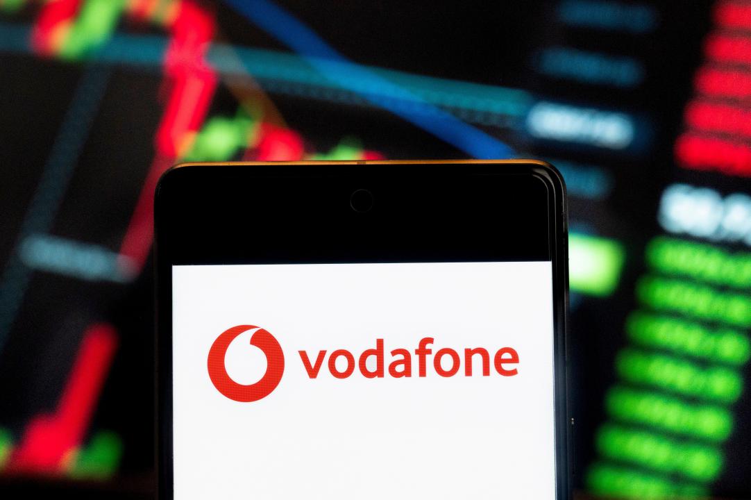 China. 22nd July, 2024. In this photo illustration, the British multinational telecommunications corporation and phone operator Vodafone (LON: VOD) logo seen displayed on a smartphone with an economic stock exchange index graph in the background. Credit: SOPA Images Limited/Alamy Live News