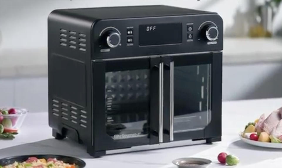 a black airfryer with two doors on a kitchen counter