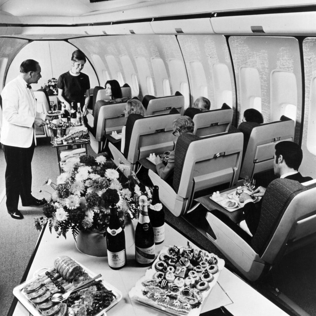 First class passengers in a BOAC Boeing 747 Jumbo Jet are served lunch