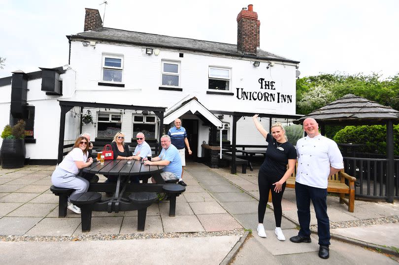 Charley Curzon, manager, and Sean Wilde, head chef, far right, with regulars at the Unicorn Inn, Cronton