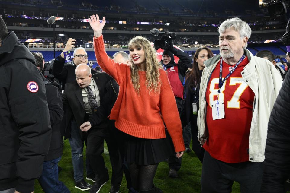 Taylor Swift waves as she walks with Ed Kelce after the AFC Championship NFL football game between the Baltimore Ravens and the Kansas City Chiefs, Sunday, Jan. 28, 2024, in Baltimore. The Chiefs won 17-10. (AP Photo/Nick Wass)
