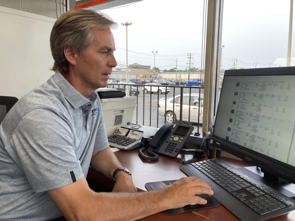 Paul Sugars, pre-owned sales manager, works on his computer at Jack Demmer Lincoln in Dearborn, Mich., on Monday, July 19, 2021. A seemingly endless streak of skyrocketing used vehicle prices is finally coming to a close in the U.S., according to the latest data (AP Photo/Mike Householder)