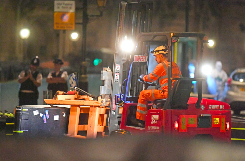 <em>A forklift truck removes the security barrier that the car crashed into (PA)</em>