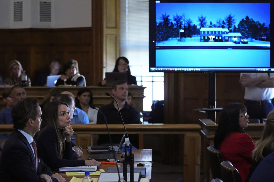 Karen Read, left, sits with her attorney Alan Jackson while a photograph of 34 Fairview Road in Canton is displayed, the location where her boyfriend John O'Keefe's body was found, during her trial at Norfolk County Superior Court, Friday, May 10, 2024, in Dedham, Mass. Read, 44, is accused of running into her Boston police officer boyfriend with her SUV in the middle of a nor'easter and leaving him for dead after a night of heavy drinking. (AP Photo/Charles Krupa, Pool)