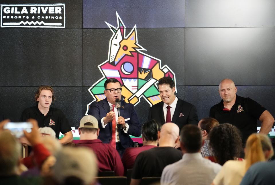Arizona Coyotes rookie Logan Cooley, President & CEO Xavier A. Gutierrez, GM Bill Armstrong, and head coach André Tourigny (right) visit with fans during media day at Ice Den Scottsdale on Sept. 12, 2023.