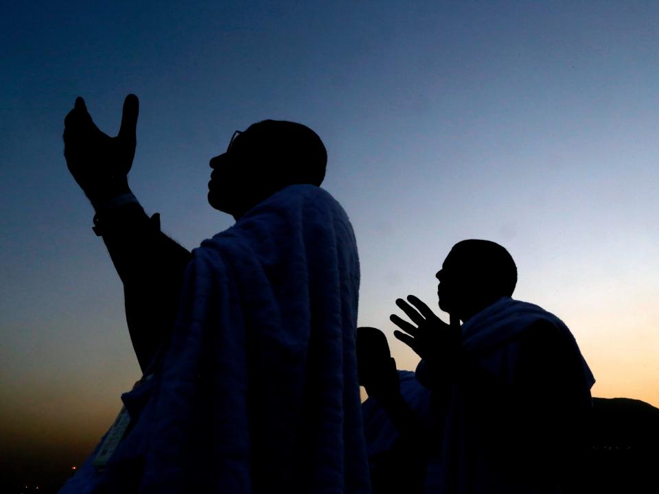 Muslim pilgrims pray on a rocky hill known as Mountain of Mercy, on the Plain of Arafat, during the annual hajj pilgrimage ahead of sunrise near the holy city of Mecca, Saudi Arabia, Saturday, Aug. 10, 2019. More than 2 million pilgrims were gathered to perform initial rites of the hajj, an Islamic pilgrimage that takes the faithful along a path traversed by the Prophet Muhammad some 1,400 years ago. (AP Photo/Amr Nabil)