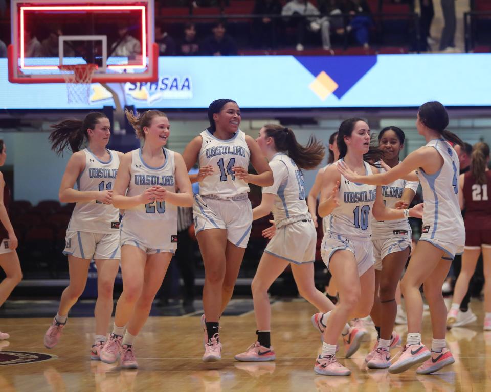 Ursuline players cheer a 3-point shot by Sophie Nascimento to end the first quarter against Harrison during the Section1 Class AA girls basketball semifinal at the Westchester County Center in White Plains Feb. 27, 2024.