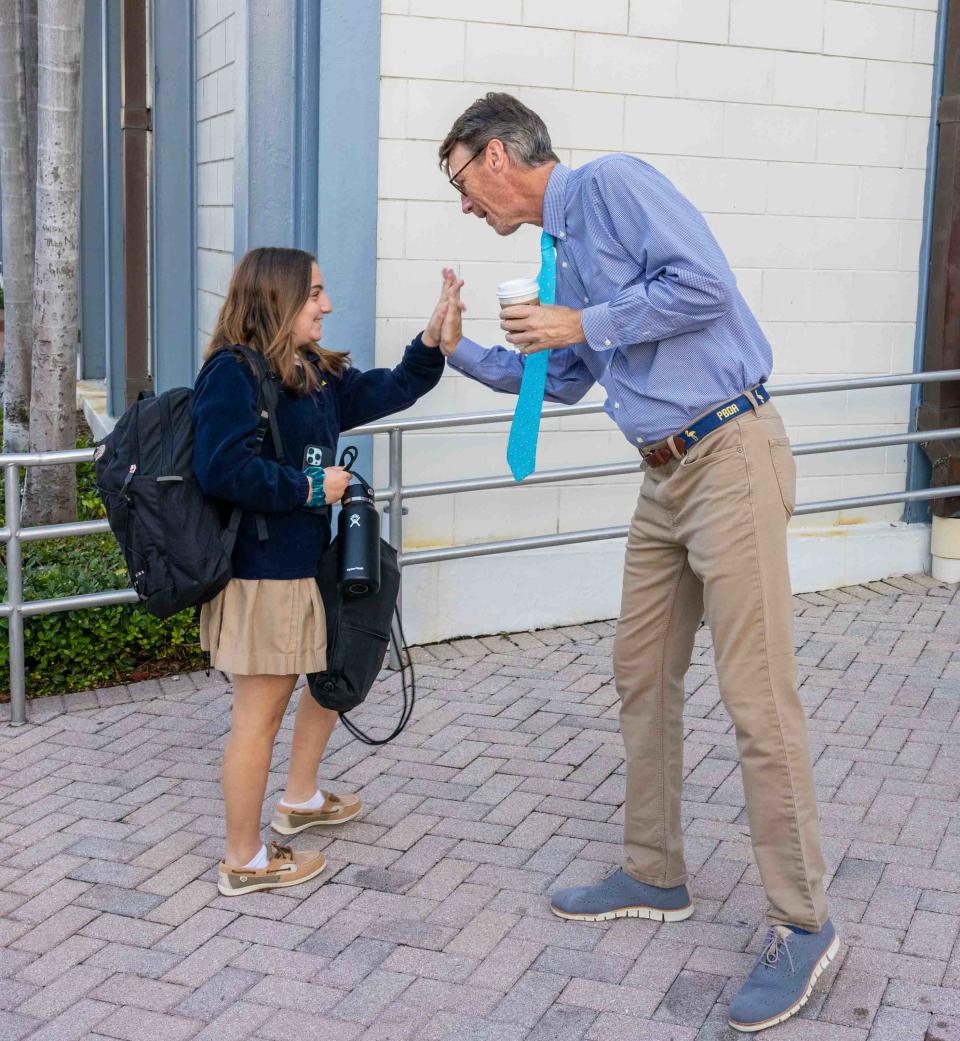 Palm Beach Day Academy student Ashley Petrelli high fives Head of School Fanning Hearon III Tuesday, the first day of the 2023-2024 school year.