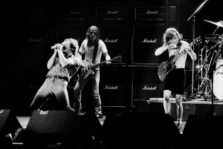 This file photo shows singer Brian Johnson performing next to guitarists Malcolm Young and Angus Young of Australian legendary hard rock band AC/DC at the Palais Omnisport of Paris Bercy, on September 15, 1984 in Paris