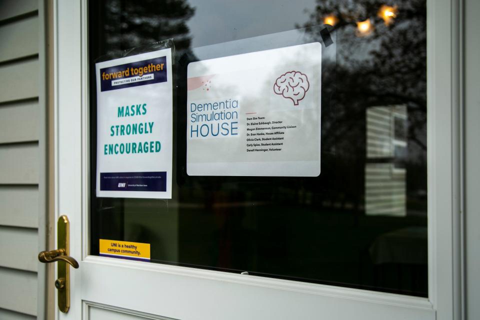 Signs are displayed on the front door at the University of Northern Iowa Dementia Simulation House, Tuesday, May 10, 2022, in Cedar Falls, Iowa.