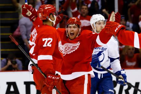 Apr 17, 2016; Detroit, MI, USA; Detroit Red Wings center Andreas Athanasiou (72) celebrates with center Joakim Andersson (18) after scoring a goal during the second period against the Tampa Bay Lightning in game three of the first round of the 2016 Stanley Cup Playoffs at Joe Louis Arena. Rick Osentoski-USA TODAY Sports