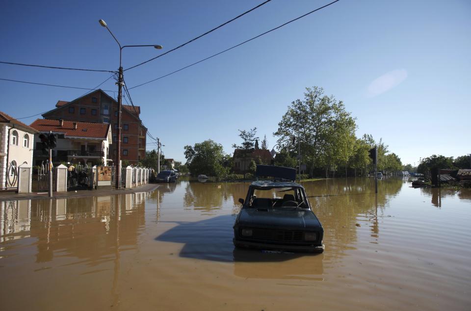 Car is seen stranded in flood waters in the town of Obrenovac