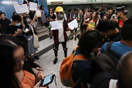Protesters call people to join further rallies against the government at Kowloon Tong subway station in Hong Kong
