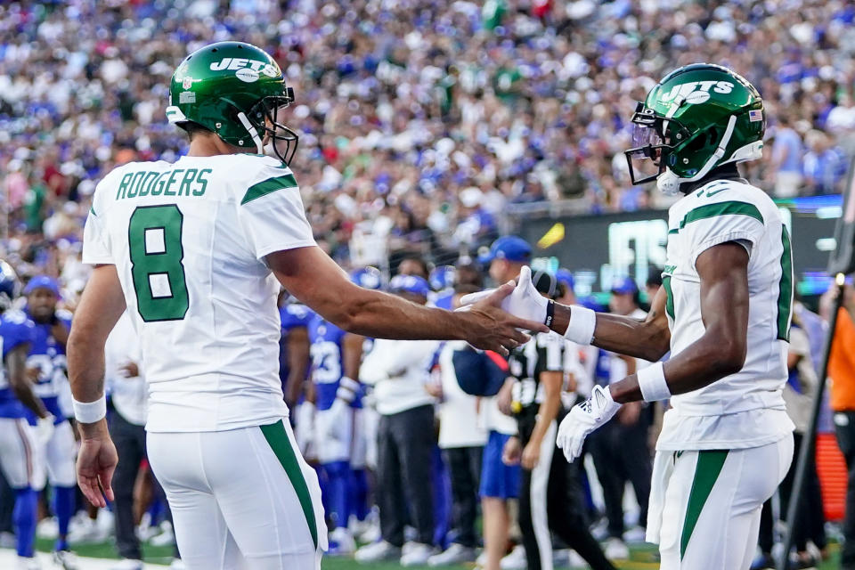 New York Jets quarterback Aaron Rodgers (8) congratulates wide receiver Garrett Wilson (17) after Wilson's touchdown catch during the first half of an NFL preseason football game against the New York Giants, Saturday, Aug. 26, 2023, in East Rutherford, N.J. (AP Photo/Frank Franklin II)