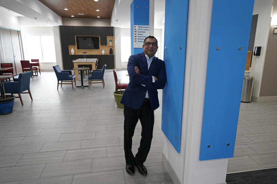 Vimal Patel president of Q Hotels, poses for a photograph at his Holiday Inn Express Hotel in LaPlace, La., Wednesday, June 23, 2021. (AP Photo/Gerald Herbert)