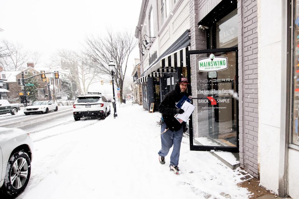 Brian Schwartz, a USPS mail carrier, makes deliveries in Doylestown Borough, during a winter storm that impacted the region on Friday, January 19, 2024.
