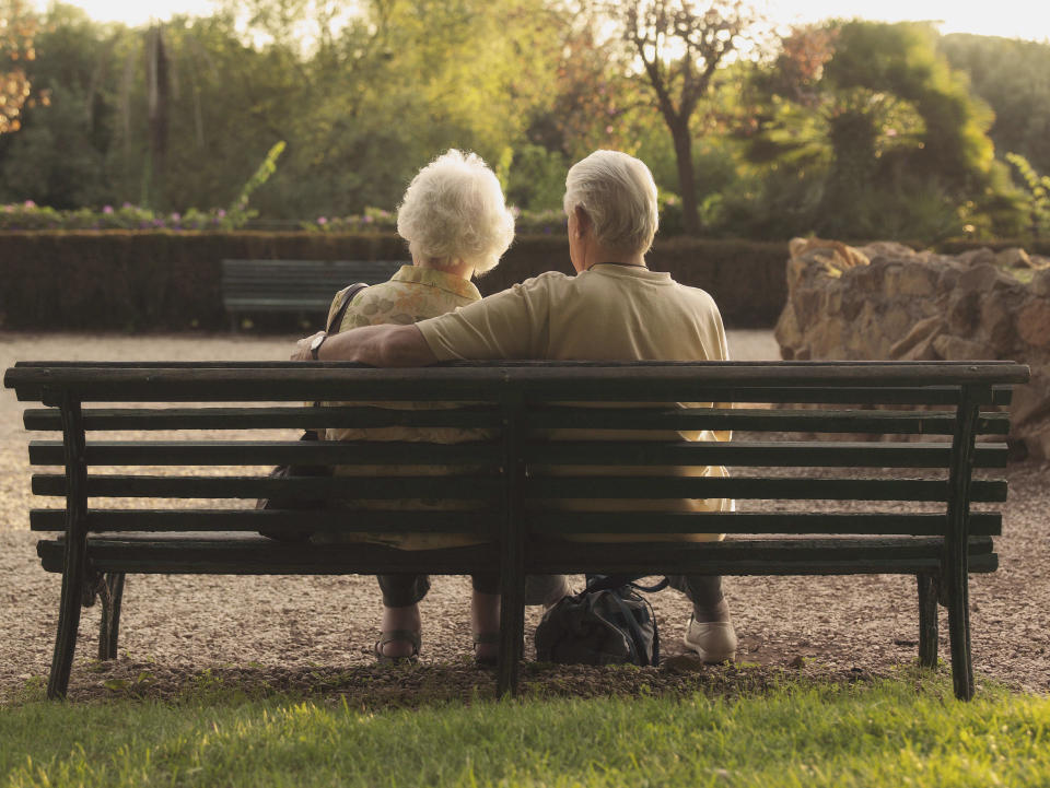 Senior couple spend time on a bench together 