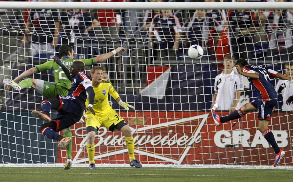 New England Revolution's Diego Fagundez, right, heads the ball into the net past Seattle Sounders' Bryan Meredith (35) in the second half of an MLS soccer game in Foxborough, Mass., Saturday, June 30, 2012. The teams tied 2-2. (AP Photo/Michael Dwyer)