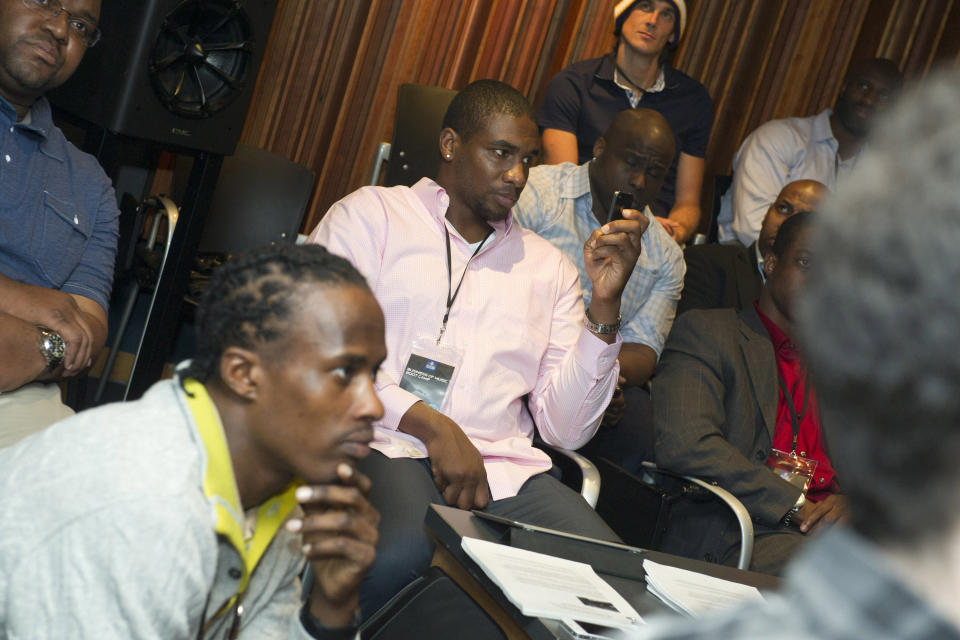 In this photo taken, Tuesday, Feb. 28, 2012, former NFL football player Darren Howard, center, takes part in the first-ever NFL Business of Music Boot Camp at New York University’s Clive Davis Institute of Recorded Music in New York. This week, the league offered an assist to current and former players like Howard who are trying to find their footing in a business that can be just as brutal and unforgiving as football. (AP Photo/Charles Sykes)