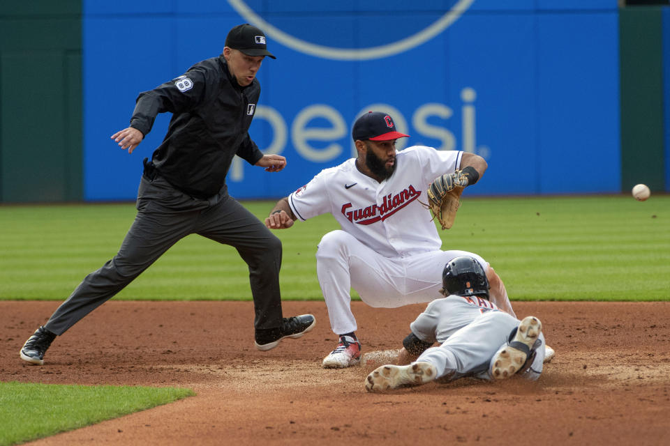 Detroit Tigers' Nick Maton, lower right, slides safely into second base with a double as Cleveland Guardians' Amed Rosario, upper right, waits for the throw and umpire Adam Hamari, left, watches during the third inning of a baseball game in Cleveland, Monday, May 8, 2023. (AP Photo/Phil Long)