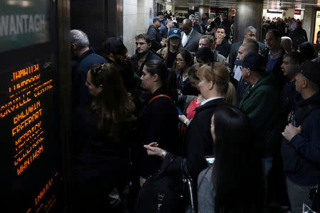 FILE PHOTO: People gather to enter a Long Island Railroad (LIRR) train line after a morning incident causing delays and cancellations leaving Pennsylvania Station in New York, U.S., April 3, 2017. REUTERS/Shannon Stapleton/File Photo