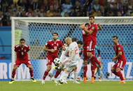 <p>David Silva shots a free kick as the Iranian wall jumps </p>