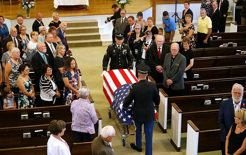 The U.S. Army Honor Guard bring in the casket of Pfc. Sanford Keith Bowen Friday, during the funeral at Ashland University's Miller Chapel.