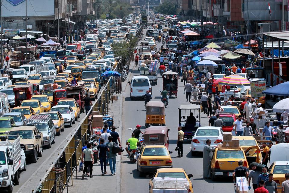 People shop in preparation for the Muslim fasting month of Ramadan, in Baghdad, Iraq, Tuesday, April 21, 2020. Ramadan begins with the new moon later this week and Muslims all around the world are trying to work out how to maintain the many cherished rituals of Islam's holiest month during the coronavirus pandemic. (AP Photo/Hadi Mizban)