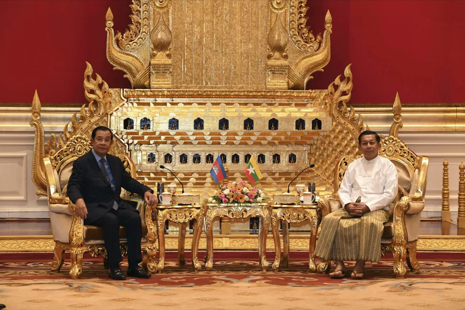 In this photo provided by An Khoun Sam Aun/National Television of Cambodia, Cambodian Prime Minister Hun Sen, left, sits together with Myanmar State Administration Council Chairman, Senior General Min Aung Hlaing, right, during a meeting in Naypyitaw, Myanmar, Friday Jan. 7, 2022. Cambodian Prime Minister Hun Sen's visit to Myanmar seeking to revive peace efforts after last year's military takeover has provoked an angry backlash among critics, who say he is legitimizing the army's seizure of power. (An Khoun SamAun/National Television of Cambodia via AP)