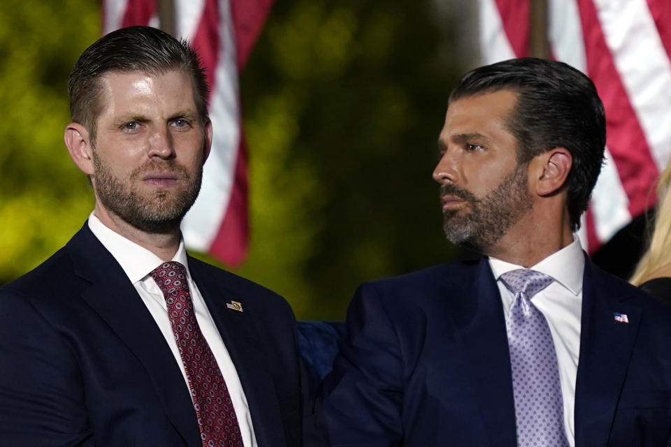 FILE - Eric Trump and Donald Trump Jr., wait for President Donald Trump to speak from the South Lawn of the White House, Aug. 27, 2020, in Washington. Donald Trump’s eldest sons are scheduled to testify in the New York civil fraud case that threatens their company’s future. Donald Trump Jr. and Eric Trump took over day-to-day management of their dad’s real estate empire when he became president. Donald Jr. is expected to testify Wednesday and Eric Trump on Thursday. (AP Photo/Evan Vucci, File)