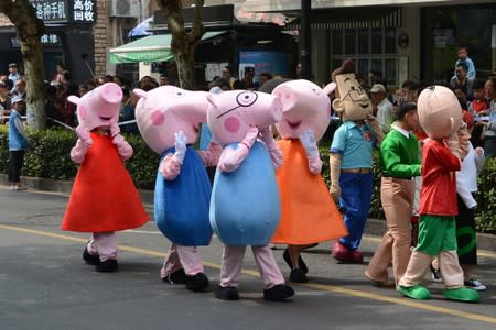 People dressed as characters from the animated series "Peppa Pig" take part in a parade during the China International Cartoon and Animation Festival in Hangzhou