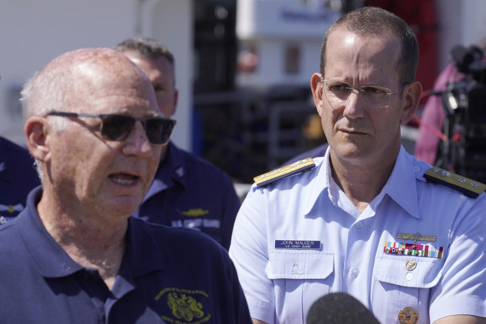 U.S. Coast Guard Rear Adm. John Mauger, commander of the First Coast Guard District, right, listens as Paul Hankins, U.S. Navy civilian contractor, supervisor of salvage, left, talks to the media, Thursday, June 22, 2023, at Coast Guard Base Boston, in Boston. The U.S. Coast Guard says the missing submersible imploded near the wreckage of the Titanic, killing all five people on board. Coast Guard officials said during the news conference that they've notified the families of the crew of the Titan, which has been missing for several days. (AP Photo/Steven Senne)