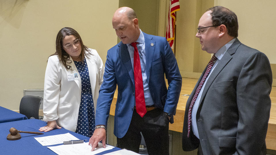 From left, Ashley Stites-Hubbard, Secretary of State Scott Schwab and Dwight Carswell prepare for a meeting of the State Objections Board on June 21, 2024, at Schwab's office