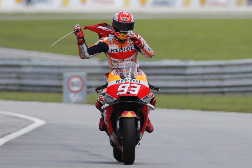 Honda rider Marc Marquez of Spain celebrates after winning the Malaysia MotoGP at the Sepang International Circuit in Sepang, Malaysia, Sunday, Nov. 4, 2018. (AP Photo/Vincent Thian)