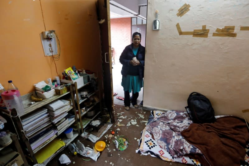 FILE PHOTO: A woman looks at damaged belongings of students of Jawaharlal Nehru University (JNU) at a hostel room after it was attacked by a mob on Sunday, in New Delhi