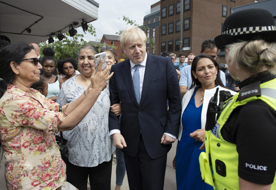 Prime Minister Boris Johnson and Home Secretary Priti Patel on a walkabout with local police during a visit to North Road, Harbourne, Birmingham before announcing his plan to recruit an extra 20,000 police officers and an urgent review will take place of plans to make it easier for forces to use stop-and-search powers.