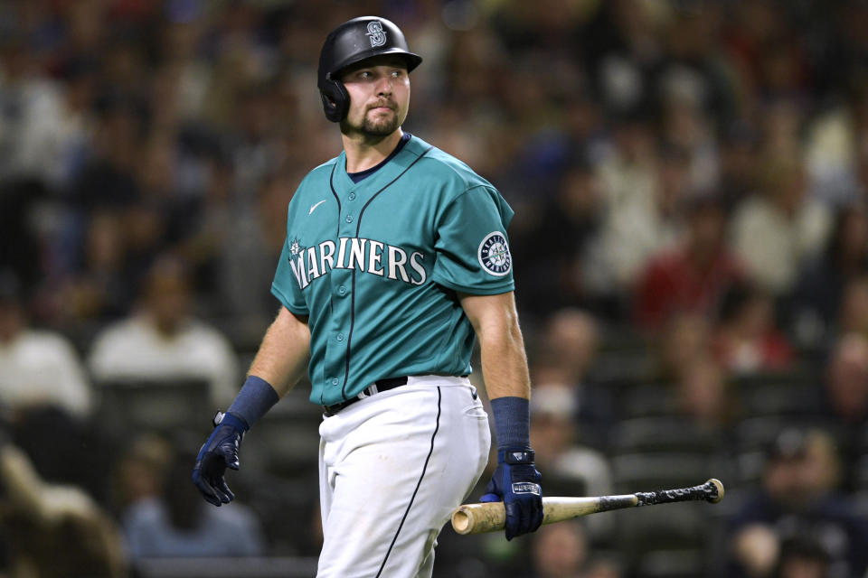 Seattle Mariners' Cal Raleigh returns to the dugout after striking out against the Atlanta Braves during the ninth inning of a baseball game Friday, Sept. 9, 2022, in Seattle. (AP Photo/Caean Couto)