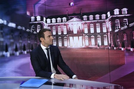 Emmanuel Macron, head of the political movement En Marche !, or Onwards !, and candidate for the 2017 presidential election, poses before taking part in the show "Elysee 2017" on French television channel TF1 in Paris, France, April 27, 2017. REUTERS/Eric Feferberg/Pool