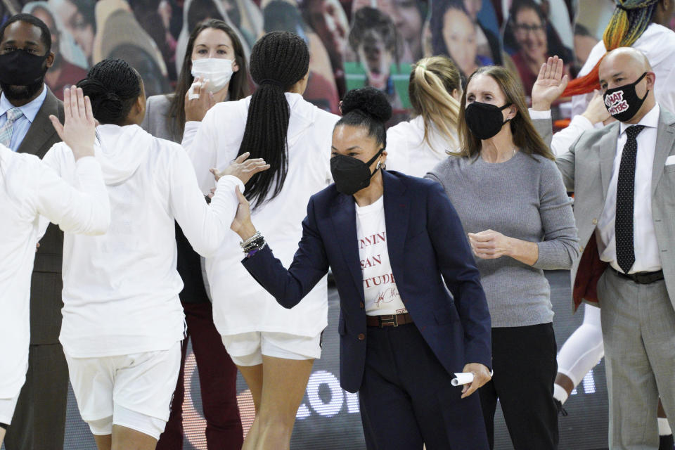 South Carolina head coach Dawn Staley high fives players before an NCAA college basketball game against Alabama Sunday, Jan. 31, 2021, in Columbia, S.C. (AP Photo/Sean Rayford)