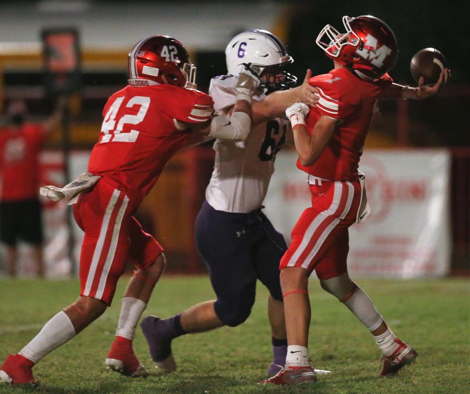 Miles High School quarterback Hayven Book is pressured by Cross Plains' Ryan Reed at Gary Krejci Memorial Stadium in Miles on Friday, Sept. 25, 2020. Miles' Brayden Dunlap tries to make a block on the play.