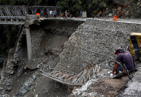 A partially damaged bridge at the height of Typhoon Haima is pictured in Benguet province, Philippines October 21, 2016. REUTERS/Erik De Castro