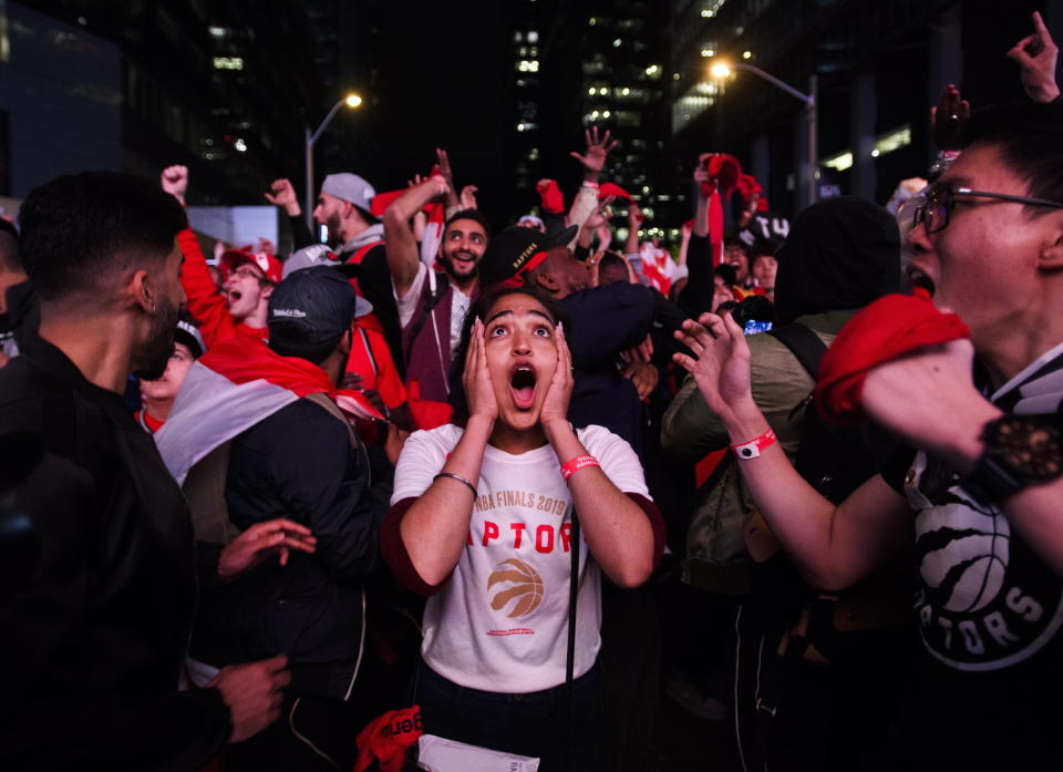 Fan reacts in Jurassic Park outside Scotiabank Arena in Toronto as the Toronto Raptors defeated the Golden State Warriors 114-110 in Game 6 of basketball’s NBA Finals, Thursday, June 13, 2019, in Oakland, Calif. (Nathan Denette/The Canadian Press via AP)