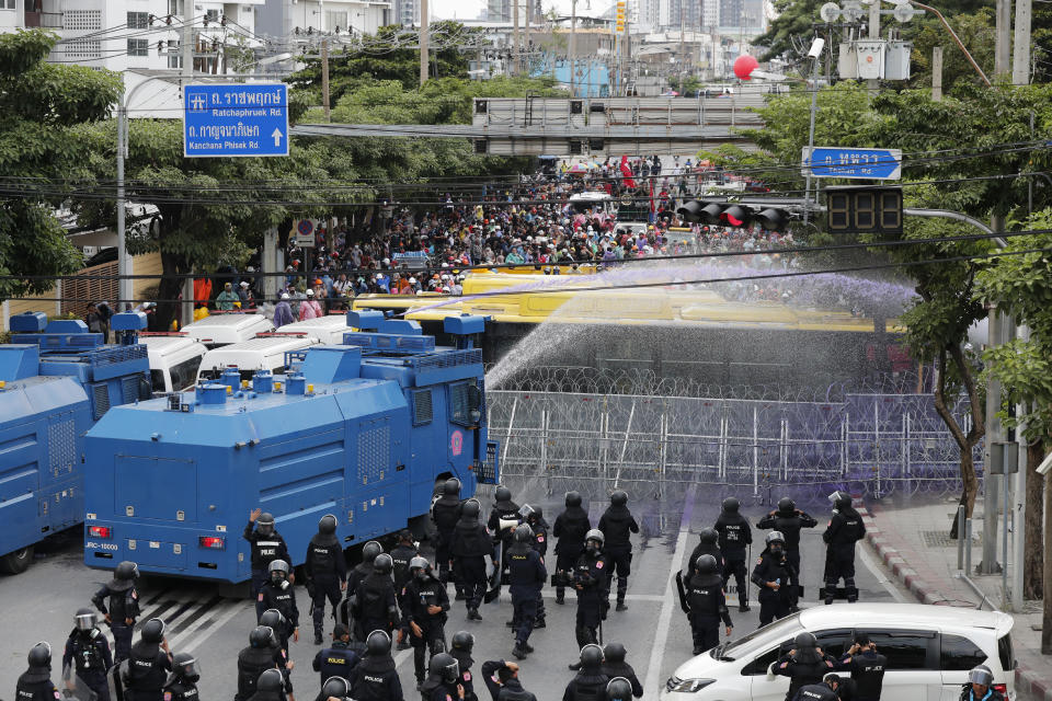 Police use water cannons to disperse pro-democracy demonstrators near the Parliament in Bangkok, Tuesday, Nov. 17, 2020. Thailand's political battleground shifted to the country's Parliament Tuesday, where lawmakers are considering proposals to amend the country's constitution, one of the core demands of the student-led pro-democracy movement. (AP Photo/Sakchai Lalit)