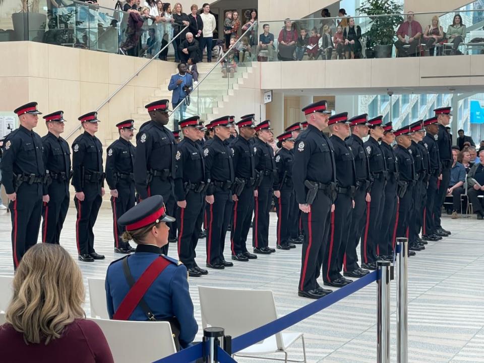 The Edmonton Police Service's latest batch of recruits during a graduation ceremony at city hall on Friday. (Andrea Huncar/CBC - image credit)