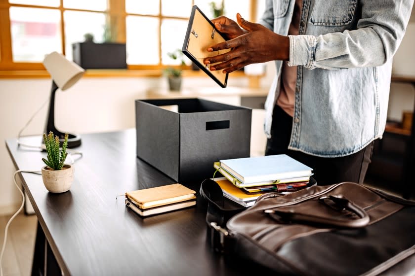 Young black man unpacking staff in his new home office