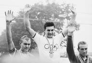 <p>Mario Zanin (center) of Italy celebrates his gold medal with silver medallist Kjell Rodian (left) of Denmark and bronze medallist Walter Godefroot (right) of Belgium after winning the Men's Individual cycle road race at the Hachioji Road Race Course.</p>