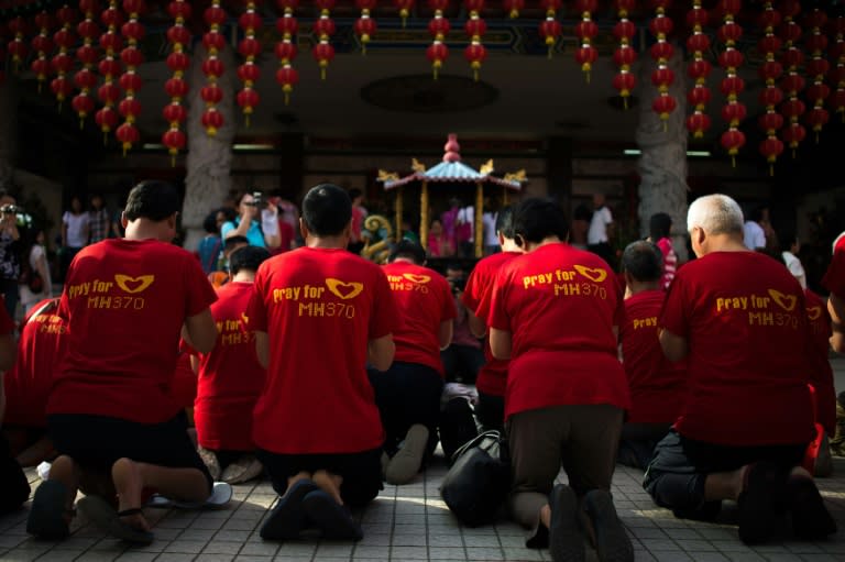 Relatives of passengers from the missing Malaysia Airlines flight MH370 offer prayers at Thean Hou Temple in Kuala Lumpur on March 1, 2015
