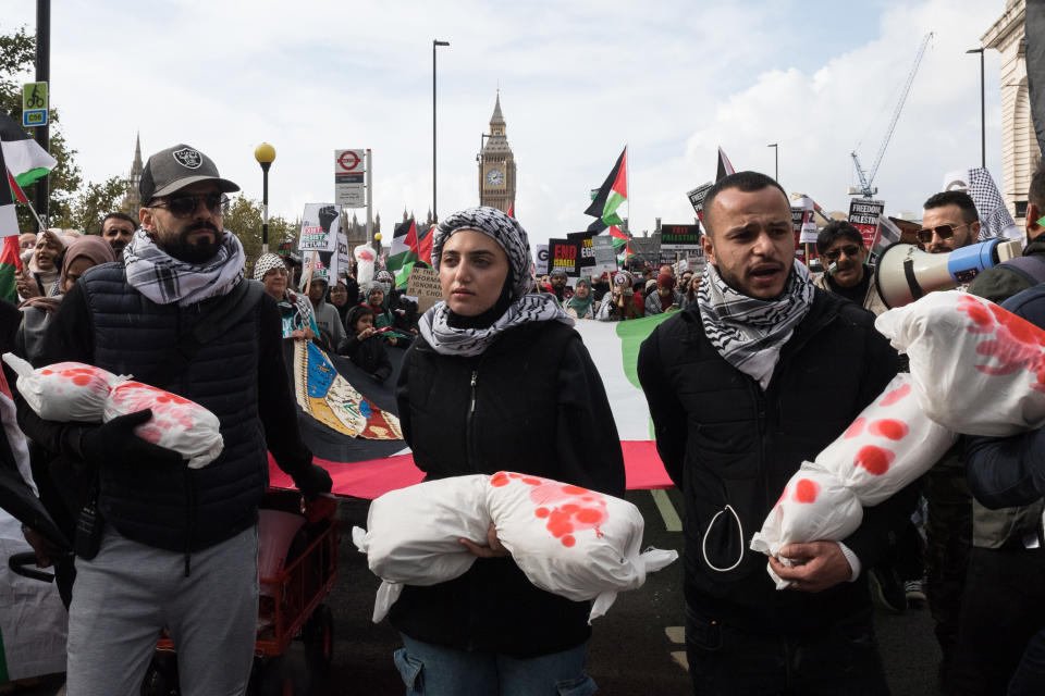 LONDON, UNITED KINGDOM - OCTOBER 28, 2023: Demonstrators carry bundles representing child casualties as tens of thousands of protesters march across Westminster Bridge in solidarity with the Palestinian people and to demand an immediate ceasefire to end the war on Gaza on October 28, 2023. Over 7,000 Palestinian and 1,400 Israeli people have died since the latest conflict between Israel and Hamas began three weeks ago when Hamas launched the largest attack on Israeli territory in decades. (Photo credit should read Wiktor Szymanowicz/Future Publishing via Getty Images)